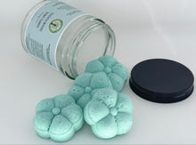 Load image into Gallery viewer, Close up of Eucalyptus Menthol Shower Steamers spilling from jar with black lid next to them