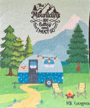 Load image into Gallery viewer, camping scene that shows mountains in the background, trees, cute little blue camper, and a small fire with 2 chairs, quote that reads " The Mountains are Calling and I must go"