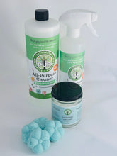 Load image into Gallery viewer, large bottle of cleaner with green label, spray bottle next to it, in front is a jar with black lid, in the very front 4 flower shaped shower steamers