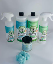 Load image into Gallery viewer, more of a top view of two spray bottles and two larger bottles of PUR Evergreen cleaner, one smaller jar with 4 flower shaped shower steamers in front