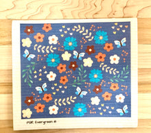 Load image into Gallery viewer, An eco-friendly Swedish dishcloth made from a blend of cotton and cellulose, with a textured surface for easy cleaning and scrubbing. The cloth is thin yet durable, and can be easily wrung out to remove excess water. It is shown in a variety of colors and patterns, with a label that reads 'Swedish Dishcloth