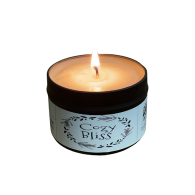 black metal candle tin with white label that reads 