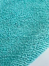 Load image into Gallery viewer, Close-up of a textured turquoise rug