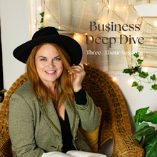 Load image into Gallery viewer, A smiling woman wearing a black wide-brim hat and olive green cardigan sits in a wicker chair with a book open in front of her. The background includes string lights, books, and greenery, with the text 'Business Deep Dive' and 'Three - Hour Sessions' overlaid on the upper right.
